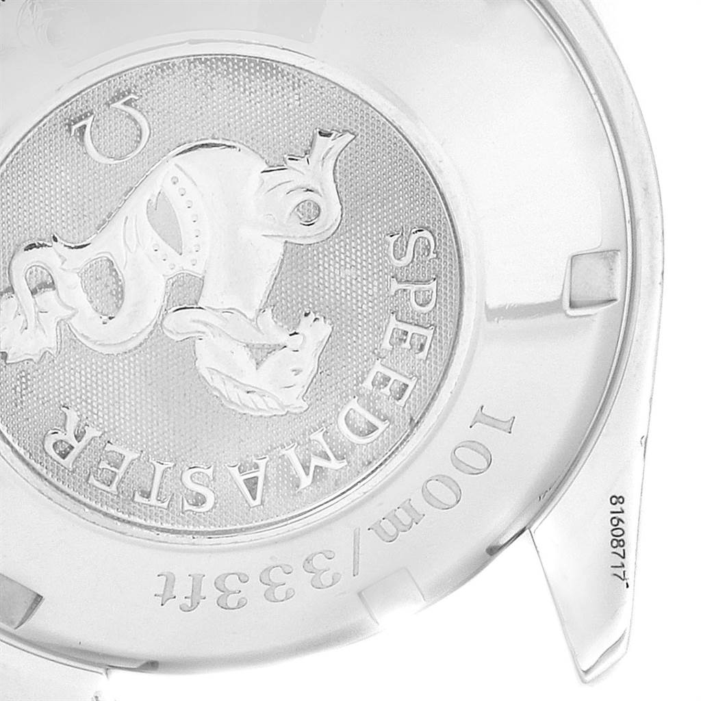 The image shows the back case cover of an Omega Speedmaster 3222.80.00 Men
s Stainless Steel Blue Dial 3222.80.00 Men
s Stainless Steel Blue Dial watch, featuring an embossed design and inscriptions.