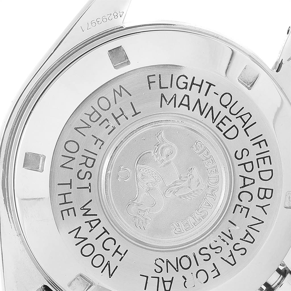 The image shows the engraved case back of an Omega Speedmaster Men's Stainless Steel Black Dial Men's Stainless Steel Black Dial wristwatch at an angle.