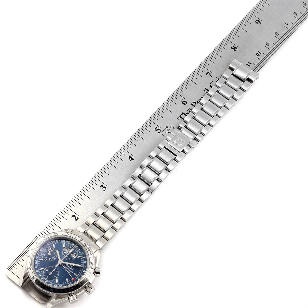 This image shows an Omega Speedmaster 3523.80.00 Men
s Stainless Steel Blue Dial 3523.80.00 Men
s Stainless Steel Blue Dial watch partially, including its bracelet stretched alongside a ruler for measurement.