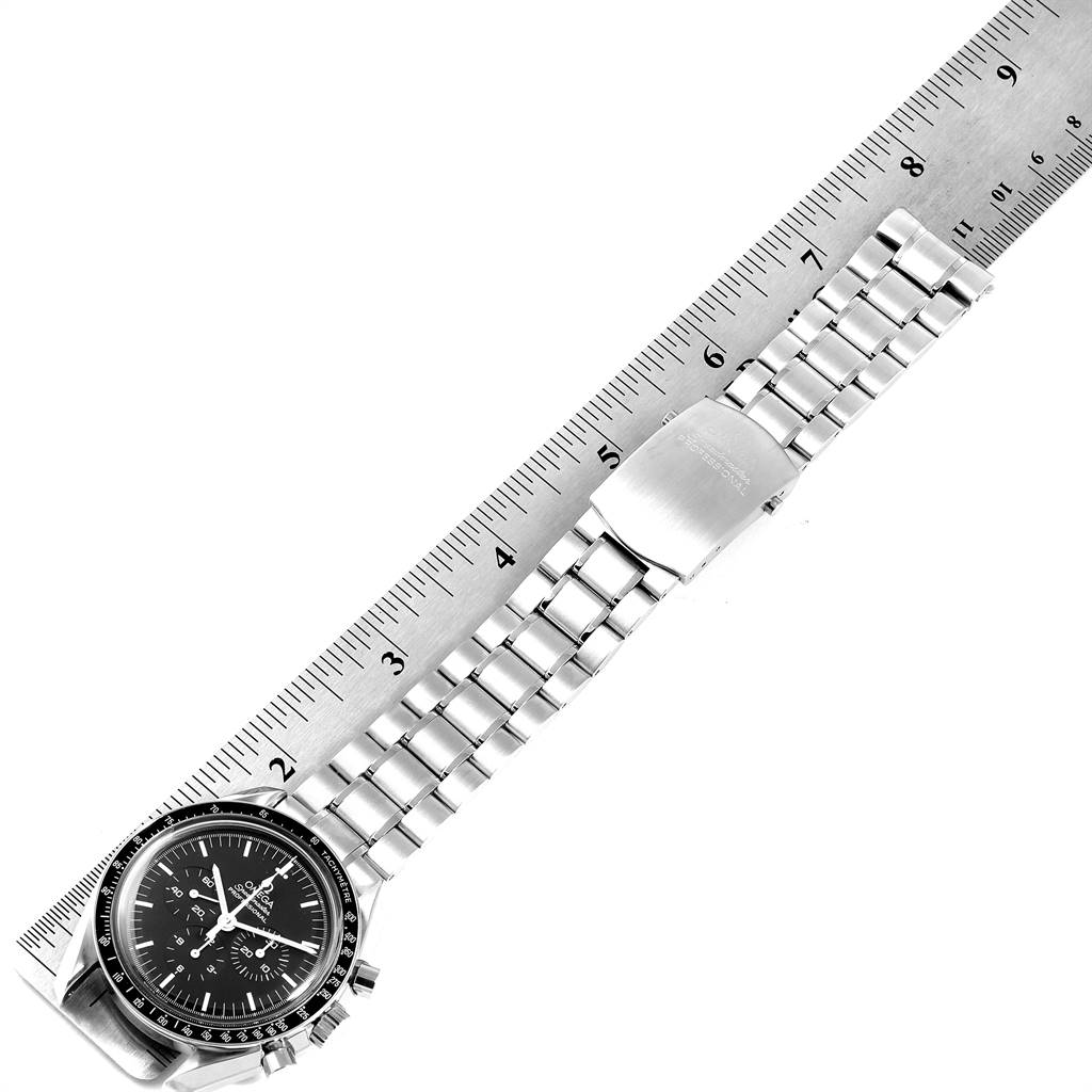 The image shows an Omega Speedmaster 3570.50.00 Men
s Stainless Steel Black Dial 3570.50.00 Men
s Stainless Steel Black Dial watch laid flat with a ruler indicating measurements.