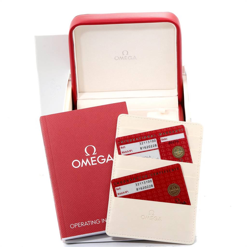 The image shows the open box, warranty cards, and operating instructions for an Omega Speedmaster 3211.31.00 Men
s Stainless Steel Silver Dial 3211.31.00 Men
s Stainless Steel Silver Dial watch.