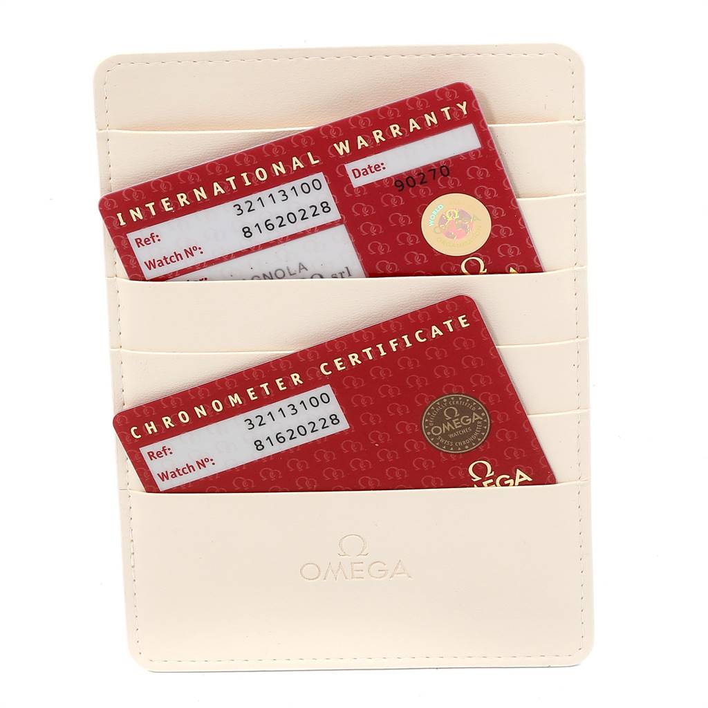 The image shows an Omega Speedmaster 3211.31.00 Men
s Stainless Steel Silver Dial 3211.31.00 Men
s Stainless Steel Silver Dial
s warranty and chronometer certificate cards in a cream cardholder.