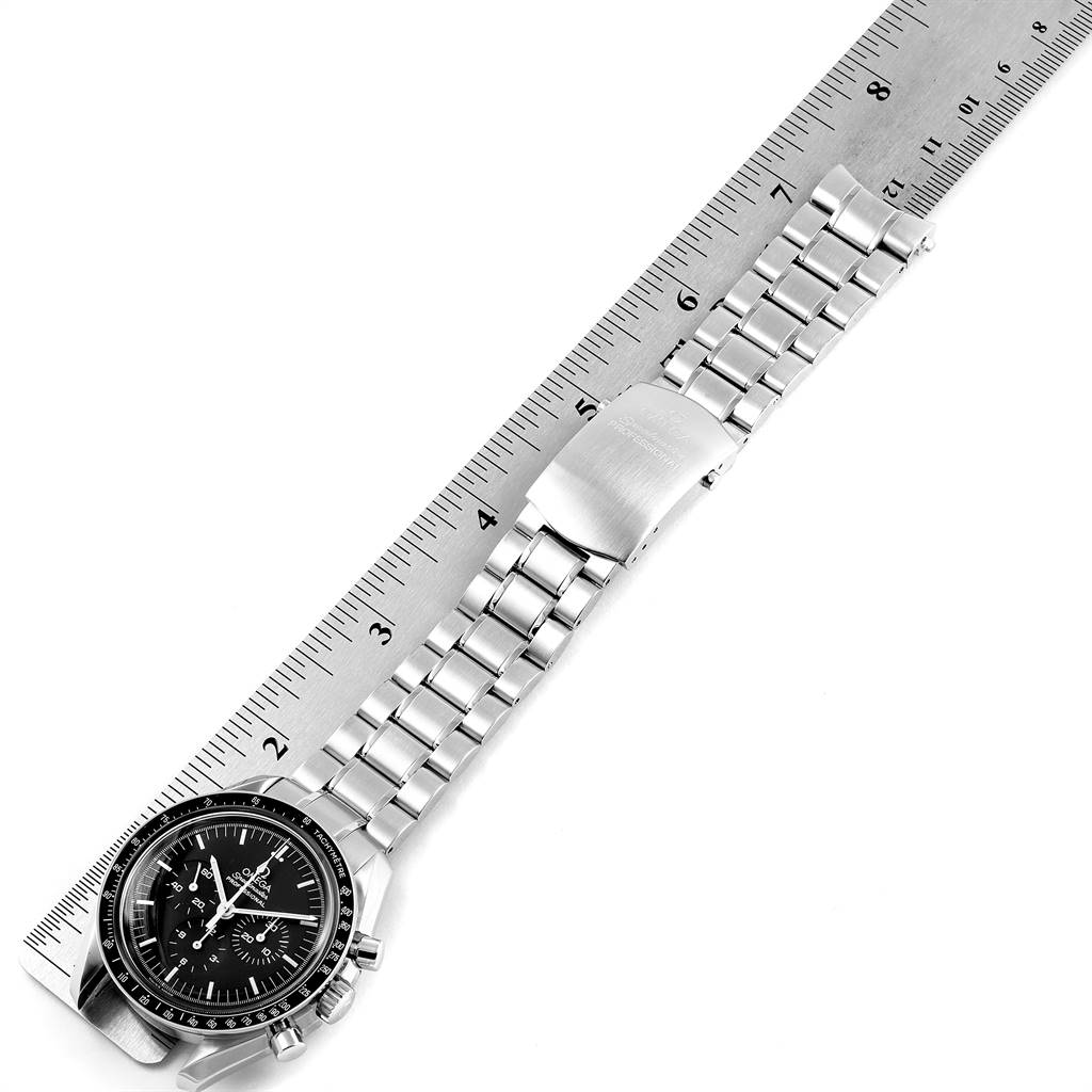 The Omega Speedmaster 3570.50.00 Men's Stainless Steel Black Dial 3570.50.00 Men's Stainless Steel Black Dial watch is shown flat with a metal bracelet and a horizontal ruler for scale.
