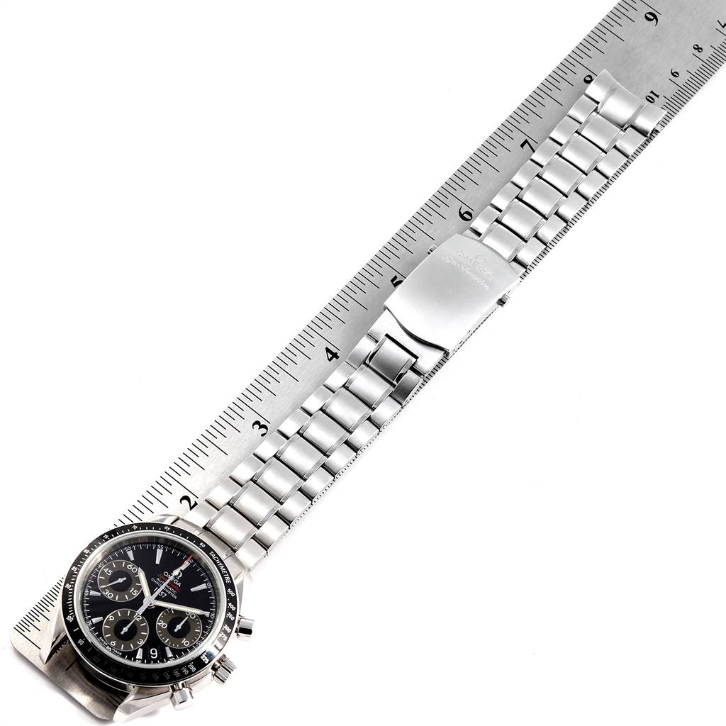 The image shows the Omega Speedmaster 323.30.40.40.01.001 Men
s Stainless Steel Black Dial 323.30.40.40.01.001 Men
s Stainless Steel Black Dial watch from a top-down angle, including the dial, bracelet, and clasp, aligned with a ruler.