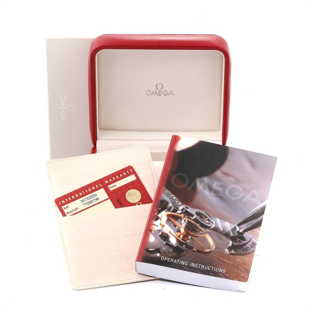 The image shows an Omega Speedmaster 3575.20.00 Men
s Stainless Steel White Dial 3575.20.00 Men
s Stainless Steel White Dial watch
s box, warranty card, and operating instructions from a front angle.