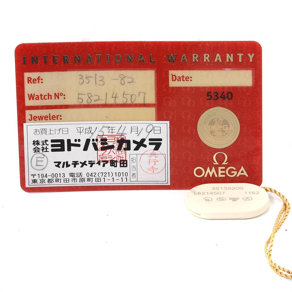 The image shows an International Warranty card and a tag for an Omega Speedmaster 3513.82.00 Men
s Stainless Steel Blue Dial 3513.82.00 Men
s Stainless Steel Blue Dial watch.