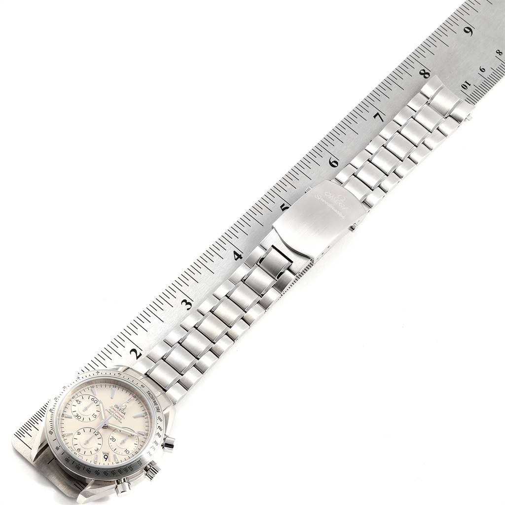 The Omega Speedmaster 323.10.40.40.02.001 Men's Stainless Steel Silver Dial 323.10.40.40.02.001 Men's Stainless Steel Silver Dial watch is shown from a top-down angle alongside a ruler, highlighting the face and metal bracelet.