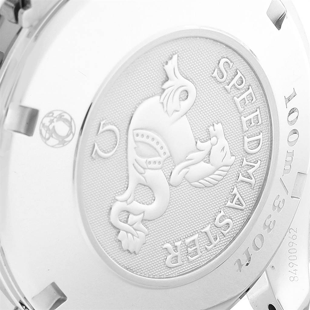 This image shows the engraved case back of an Omega Speedmaster 323.10.40.40.02.001 Men's Stainless Steel Silver Dial 323.10.40.40.02.001 Men's Stainless Steel Silver Dial watch at an angled view.