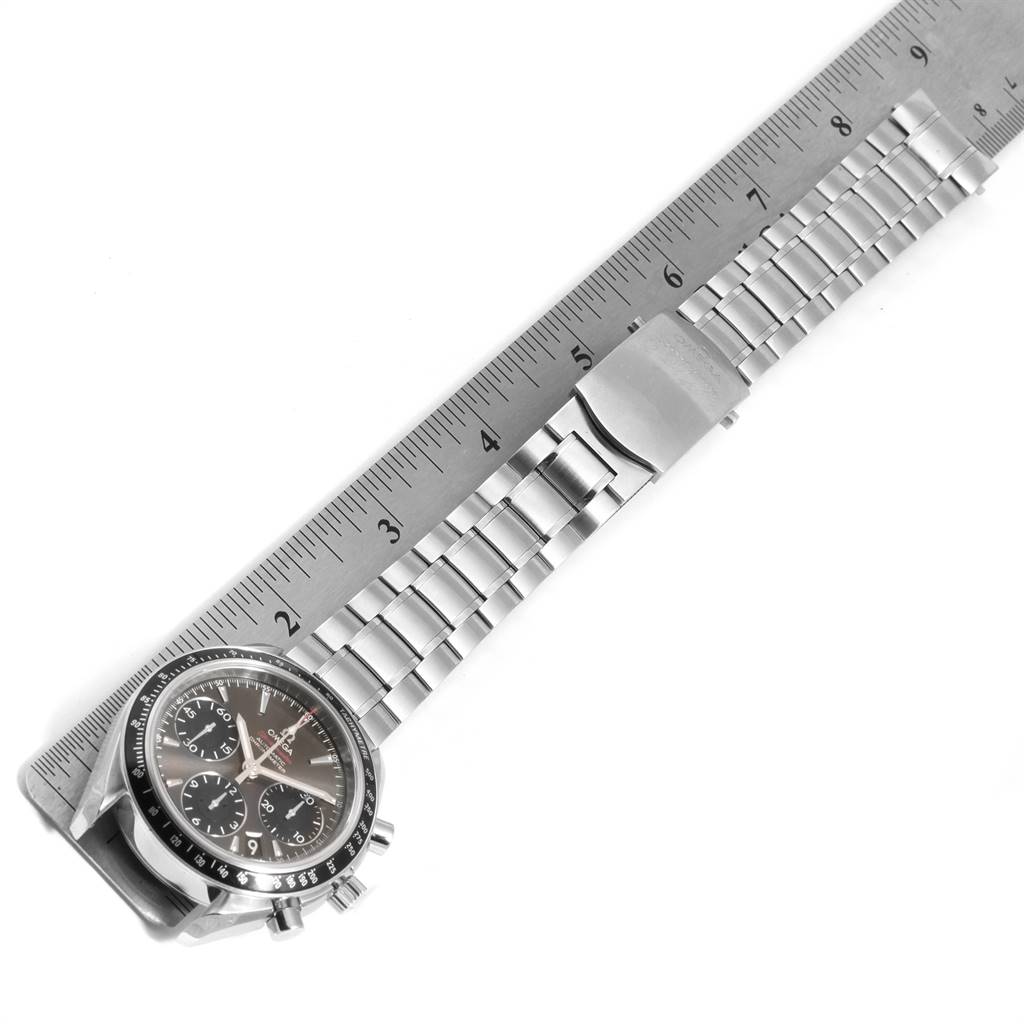 The Omega Speedmaster 323.30.40.40.06.001 Men
s Stainless Steel Grey Dial 323.30.40.40.06.001 Men
s Stainless Steel Grey Dial watch is shown from a top-down angle, highlighting the dial, bracelet, and clasp alongside a ruler for scale.