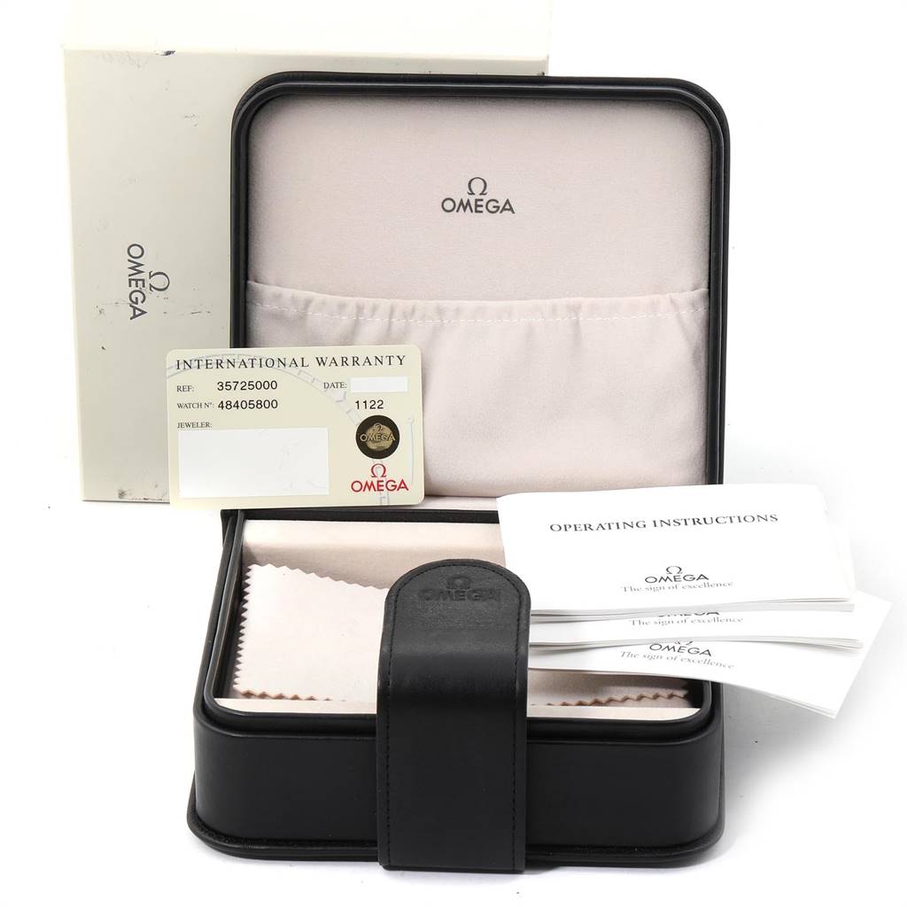 The image shows an Omega Speedmaster 3572.50.00 Men
s Stainless Steel Black Dial 3572.50.00 Men
s Stainless Steel Black Dial
s open box with a warranty card, operating instructions, and cleaning cloth visible.