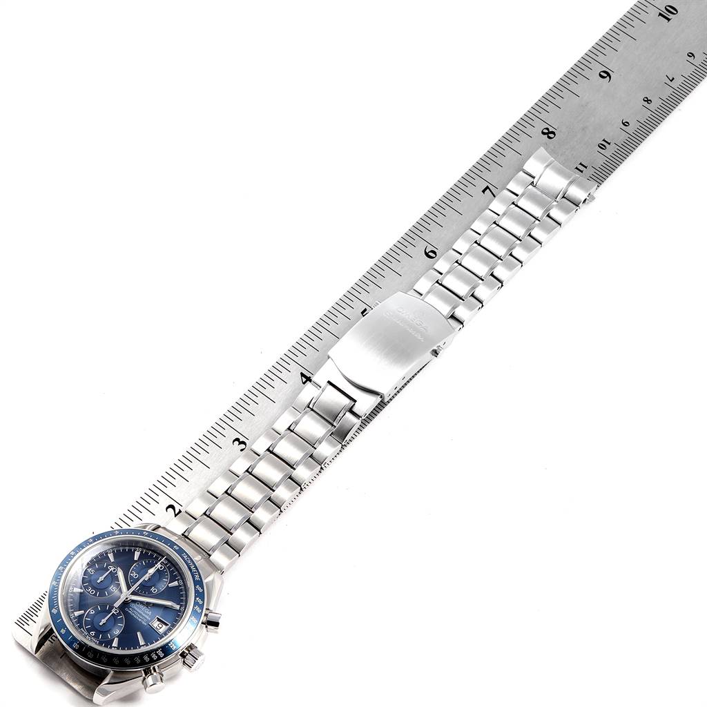 The image shows an Omega Speedmaster 3212.80.00 Men's Stainless Steel Blue Dial 3212.80.00 Men's Stainless Steel Blue Dial watch lying flat, with the entire bracelet laid out next to a ruler for size reference.
