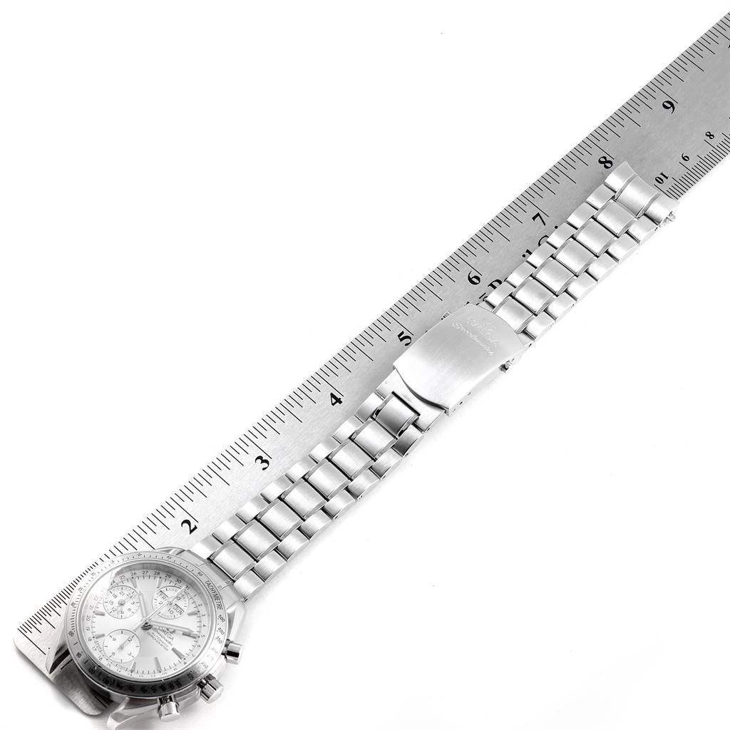 The Omega Speedmaster 3221.30.00 Men
s Stainless Steel Silver Dial 3221.30.00 Men
s Stainless Steel Silver Dial watch is shown from an overhead angle, highlighting its bracelet and face alongside a ruler for scale.