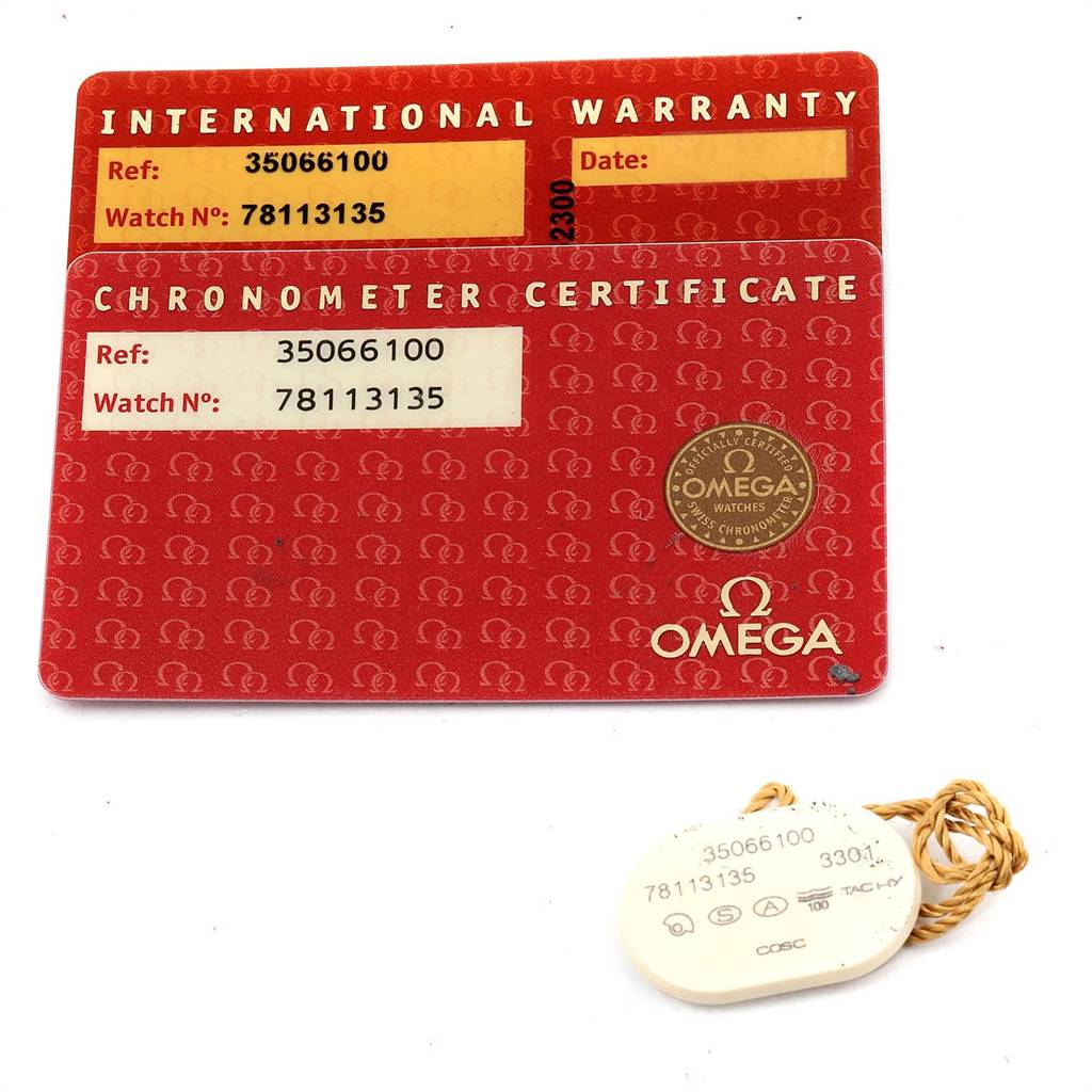 The image shows two Omega Speedmaster 3506.61.00 Men's Stainless Steel Red Dial 3506.61.00 Men's Stainless Steel Red Dial cards, an International Warranty and Chronometer Certificate, and a hang tag, all laid flat.