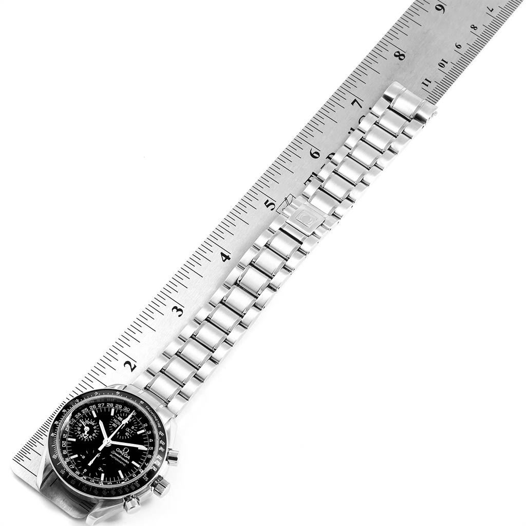 The Omega Speedmaster 3520.50.00 Men
s Stainless Steel Black Dial 3520.50.00 Men
s Stainless Steel Black Dial watch is shown at a slight angle with its stainless steel bracelet laid along a ruler.