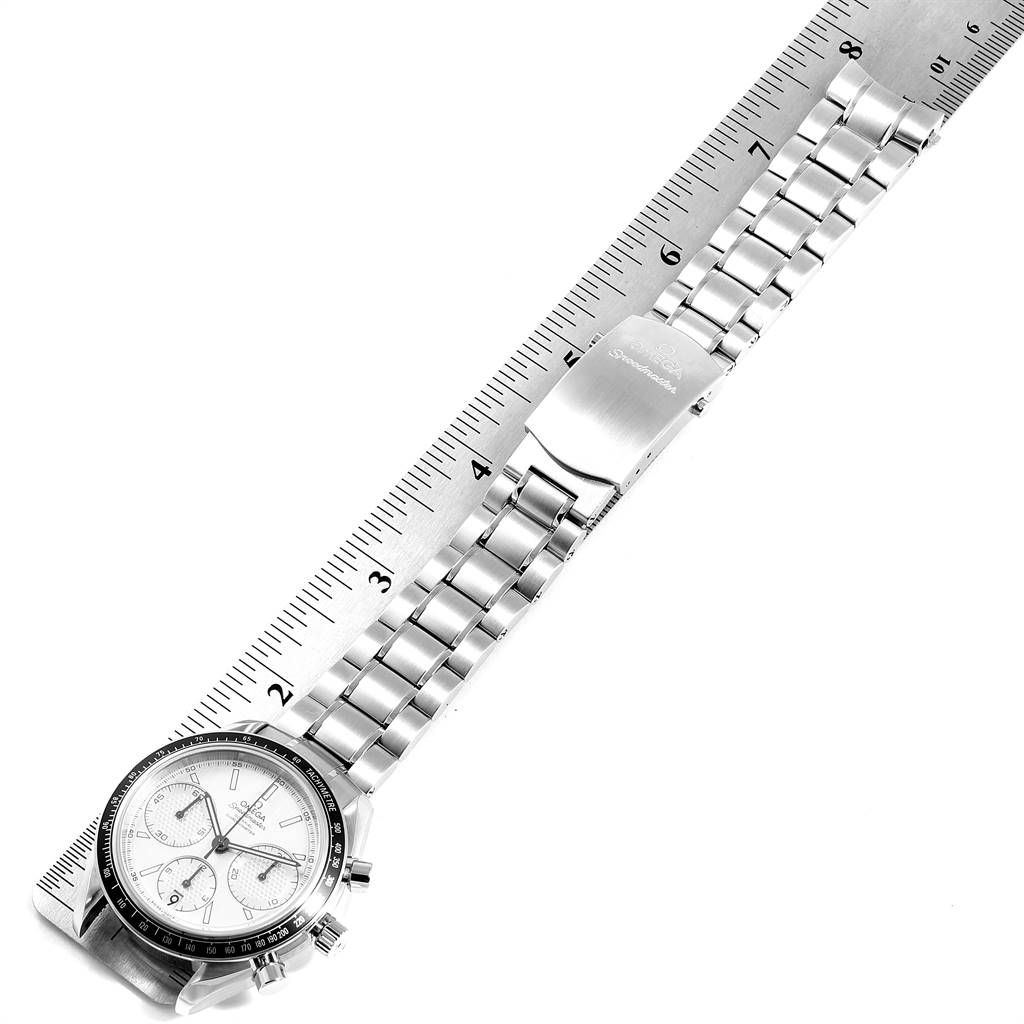 The image shows an Omega Speedmaster 326.30.40.50.01.001 Men
s Stainless Steel Silver Dial 326.30.40.50.01.001 Men
s Stainless Steel Silver Dial watch laid flat against a ruler, displaying its bracelet, clasp, and face.