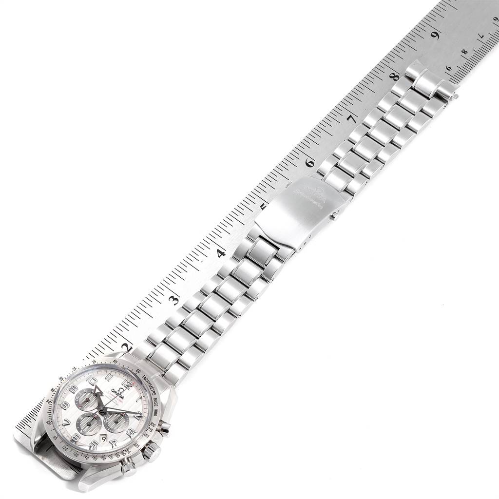 The Omega Speedmaster 321.10.44.50.02.001 Men
s Stainless Steel Silver Dial 321.10.44.50.02.001 Men
s Stainless Steel Silver Dial watch is shown at an oblique angle, displaying its face and metal bracelet next to a ruler.