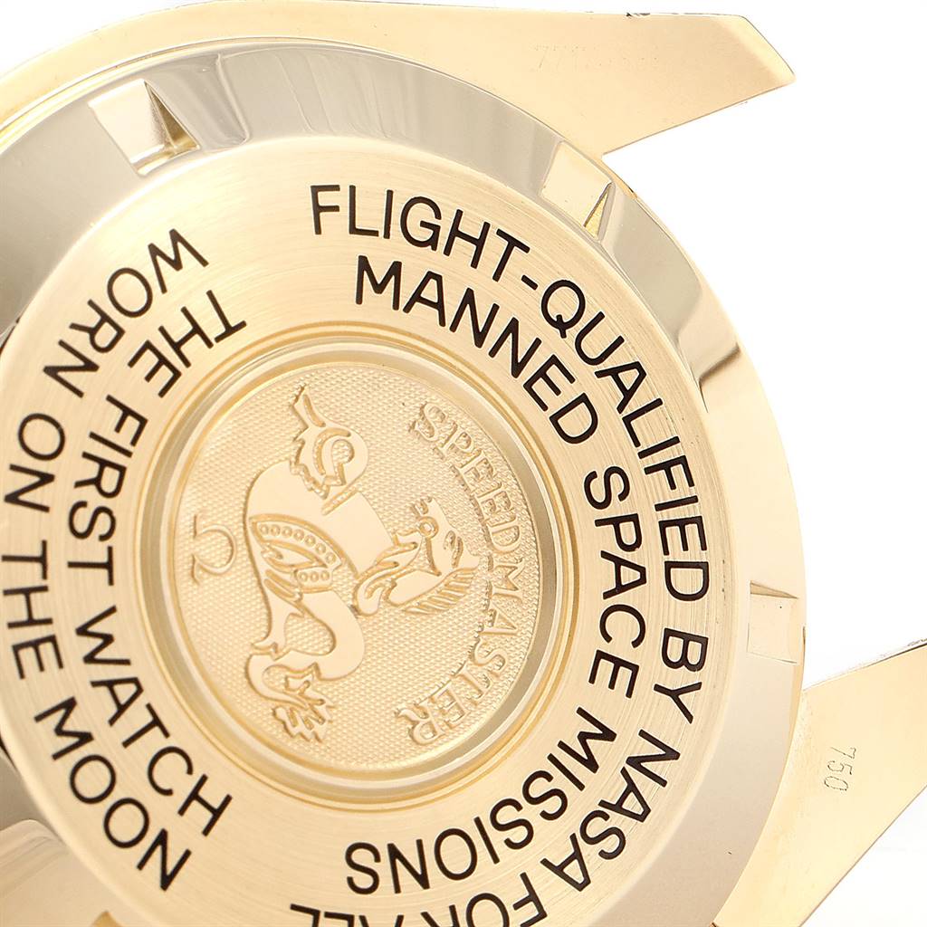 The image shows the back case of an Omega Speedmaster 3695.50.31 Men's Yellow Gold Black Dial 3695.50.31 Men's Yellow Gold Black Dial watch, highlighting its engraved text and emblem.