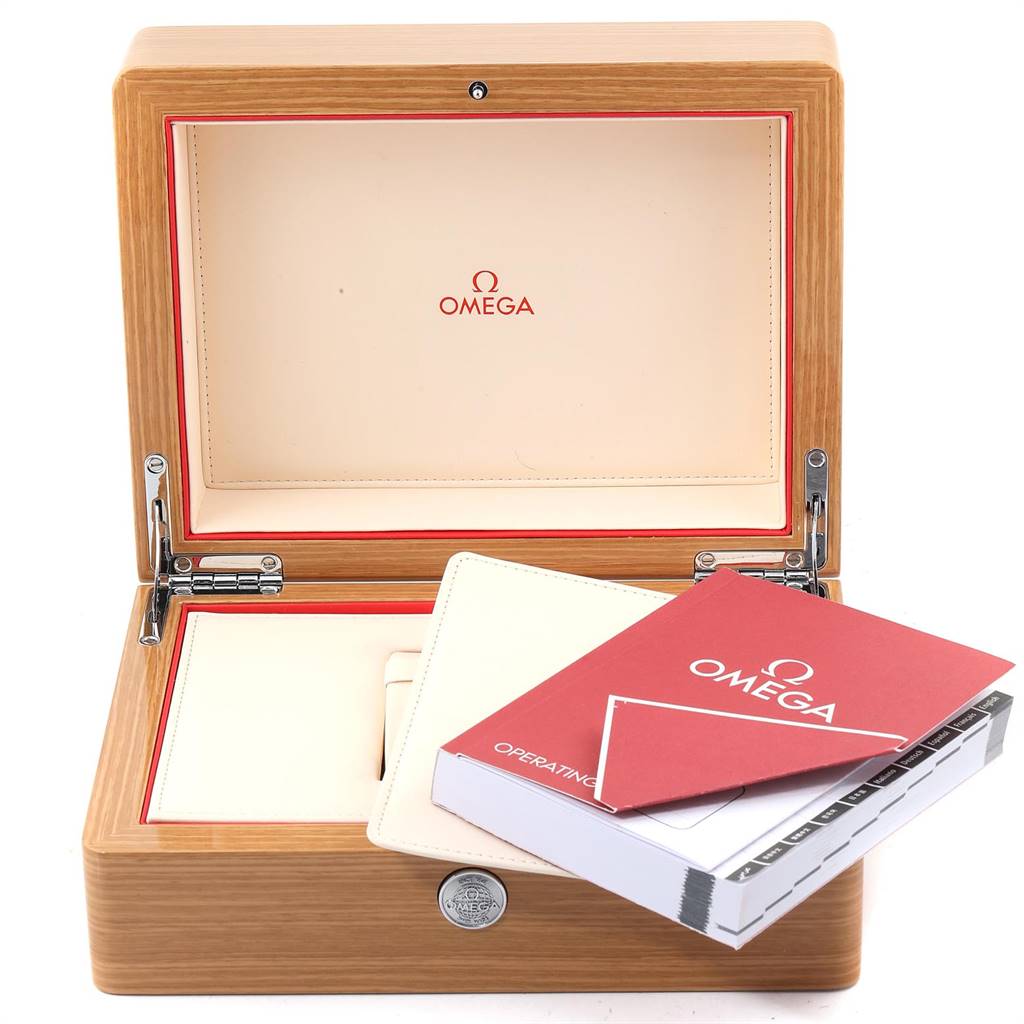 The image shows an open Omega Speedmaster 3695.50.31 Men's Yellow Gold Black Dial 3695.50.31 Men's Yellow Gold Black Dial watch box with accompanying manuals and documents.