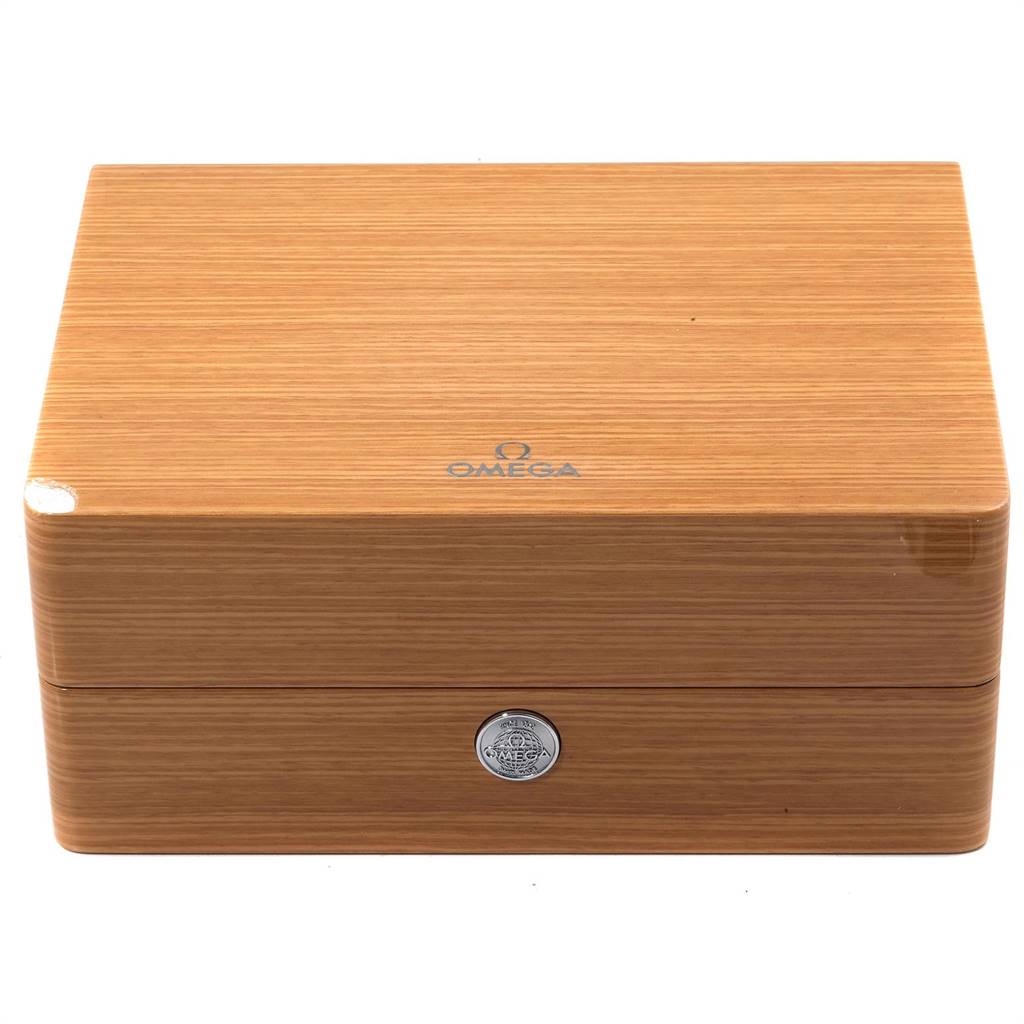 The image shows a wooden Omega Speedmaster 3695.50.31 Men's Yellow Gold Black Dial 3695.50.31 Men's Yellow Gold Black Dial watch box from a front angle, featuring the Omega logo and a metallic insignia.