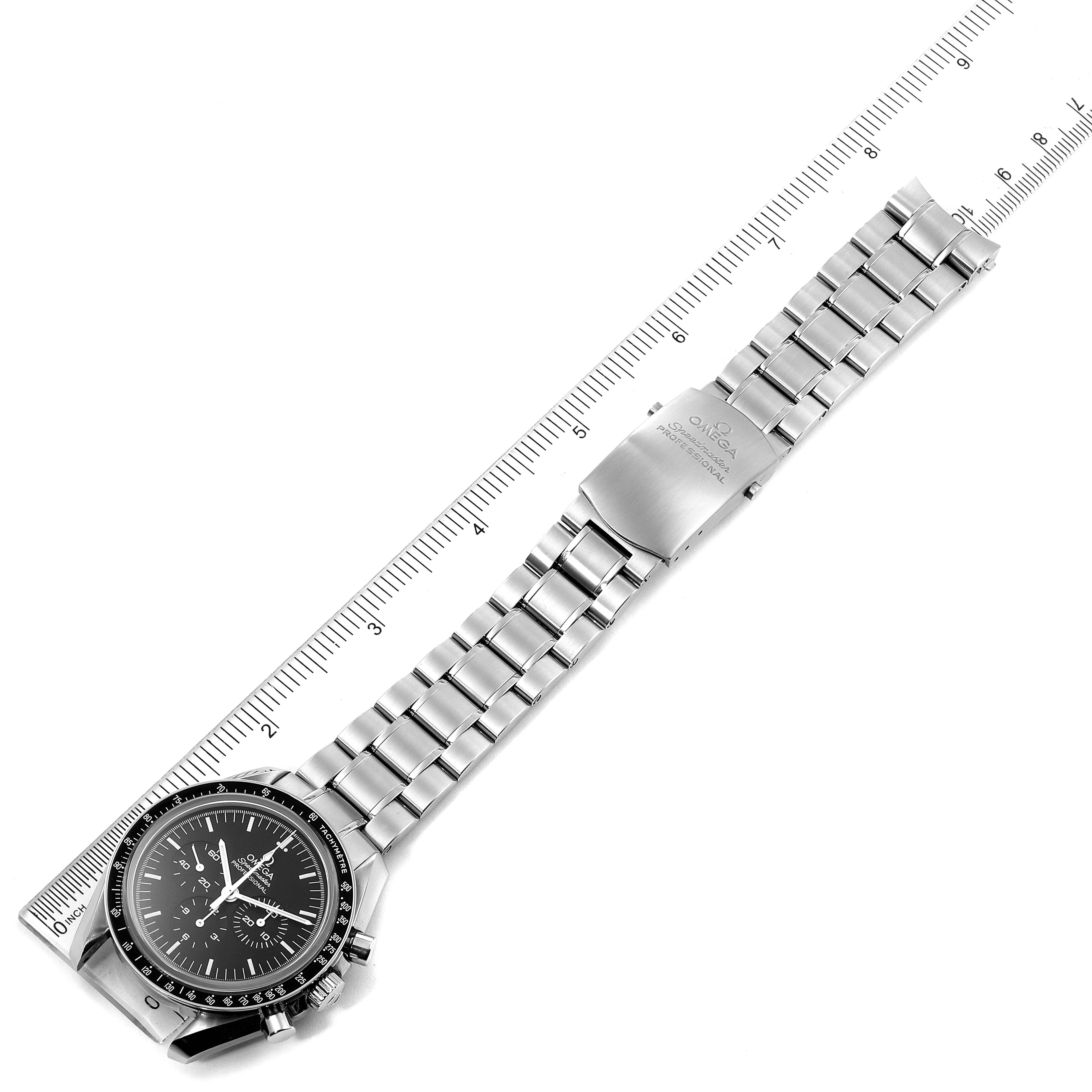 The image shows an Omega Speedmaster 311.30.42.30.01.006 Men
s Stainless Steel Black Dial 311.30.42.30.01.006 Men
s Stainless Steel Black Dial watch laid flat with its face and stainless steel bracelet aligned with a ruler.