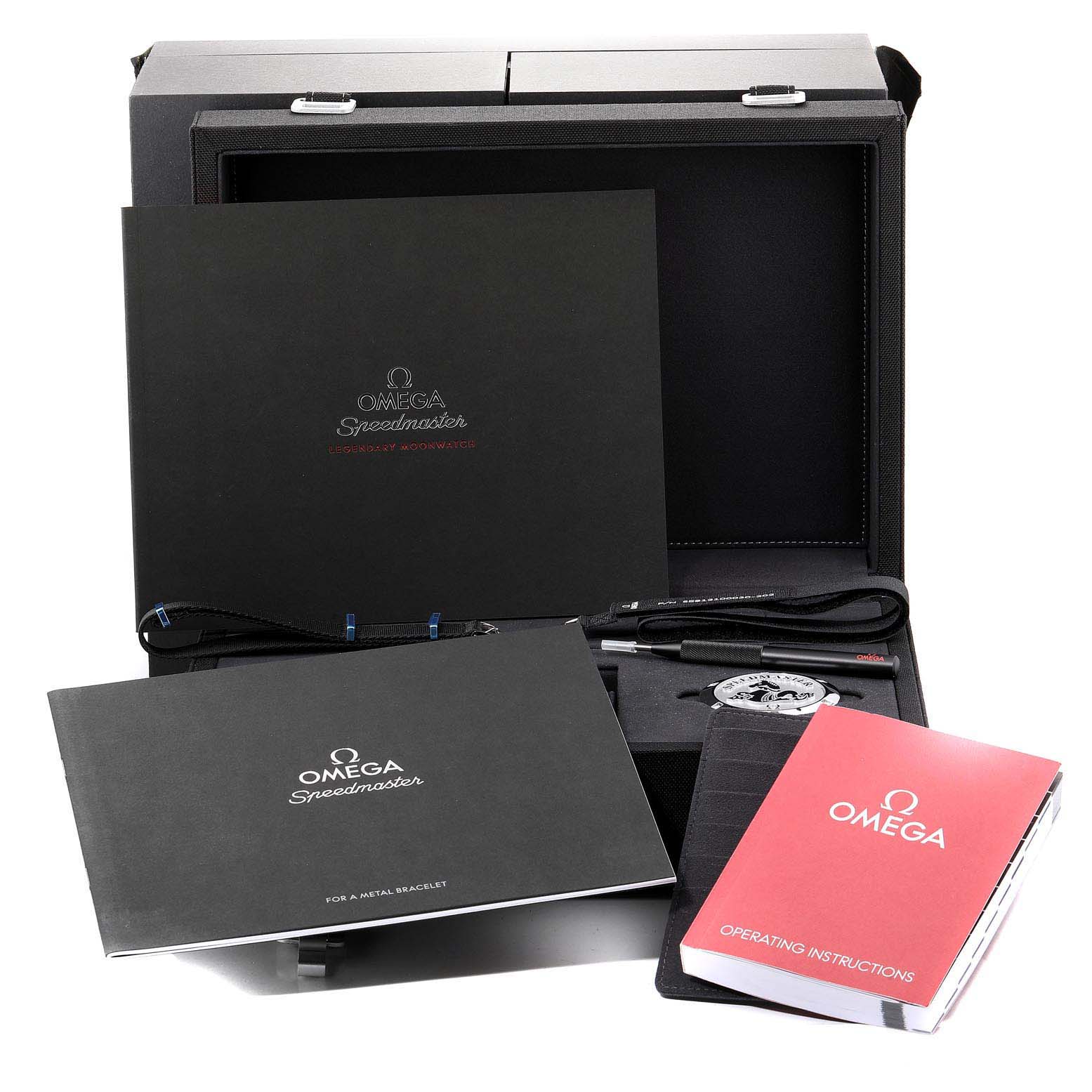 The image shows an Omega Speedmaster 311.30.42.30.01.006 Men
s Stainless Steel Black Dial 311.30.42.30.01.006 Men
s Stainless Steel Black Dial watch box set with manuals, a loupe, tool, and other accessories.