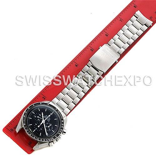 The Omega Speedmaster SPEEDMASTER PROFESSIONAL Men
s Stainless Steel Black Dial SPEEDMASTER PROFESSIONAL Men
s Stainless Steel Black Dial watch is shown from an overhead angle, fully extended and placed alongside a red ruler.