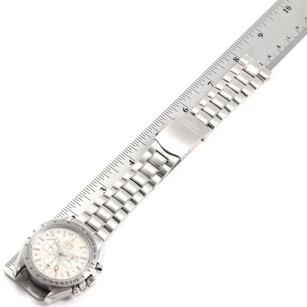 The image shows an Omega Speedmaster 3581.30.00 Men's Stainless Steel White Dial 3581.30.00 Men's Stainless Steel White Dial watch laid flat with its bracelet and clasp fully extended, aligned against a ruler.