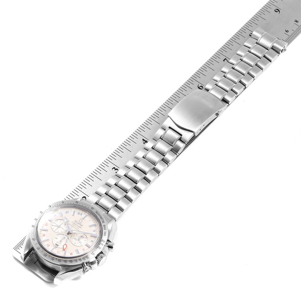 The image shows an Omega Speedmaster 3581.30.00 Men
s Stainless Steel White Dial 3581.30.00 Men
s Stainless Steel White Dial watch from an overhead angle, highlighting the face, bracelet, and clasp next to a ruler.