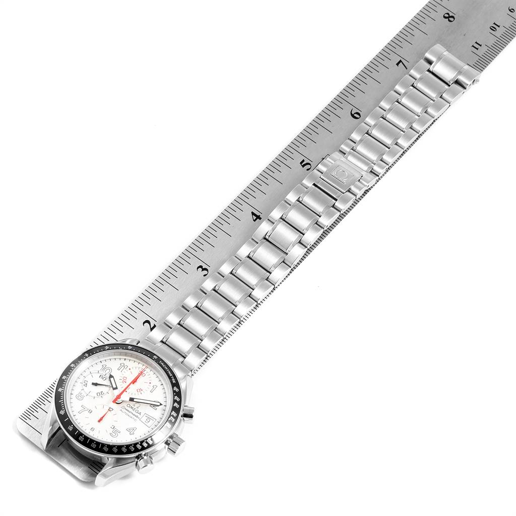 The image shows an Omega Speedmaster 3513.33.00 Men
s Stainless Steel White Dial 3513.33.00 Men
s Stainless Steel White Dial watch laid flat with its face and metal bracelet aligned next to a ruler.