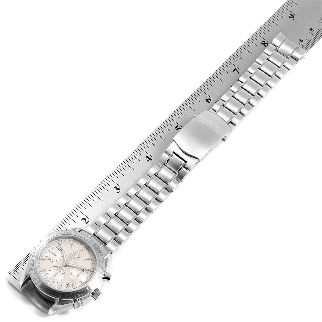 The image shows an Omega Speedmaster 323.10.40.40.02.001 Men
s Stainless Steel Silver Dial 323.10.40.40.02.001 Men
s Stainless Steel Silver Dial watch laid against a ruler, displaying the face, bezel, and metal bracelet.