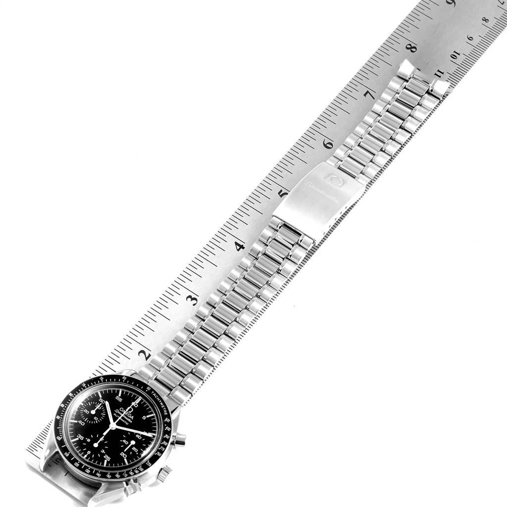 The image shows an Omega Speedmaster 3510.50.00 Men
s Stainless Steel Black Dial 3510.50.00 Men
s Stainless Steel Black Dial watch laid flat along a metal ruler, showcasing its face and stainless steel bracelet.