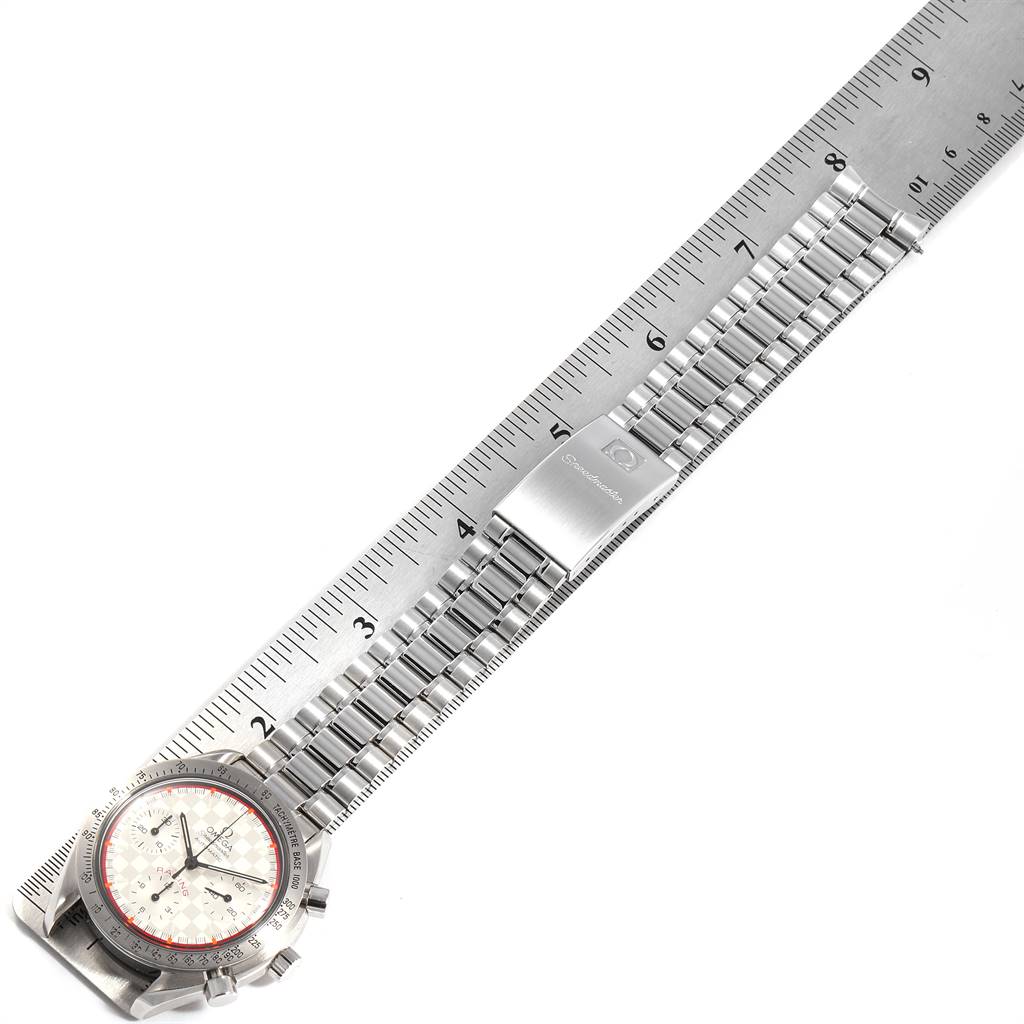 This image shows an Omega Speedmaster 3517.30.00 Men's Stainless Steel Silver Dial 3517.30.00 Men's Stainless Steel Silver Dial watch, laid flat with its metallic bracelet and clasp, next to a ruler.