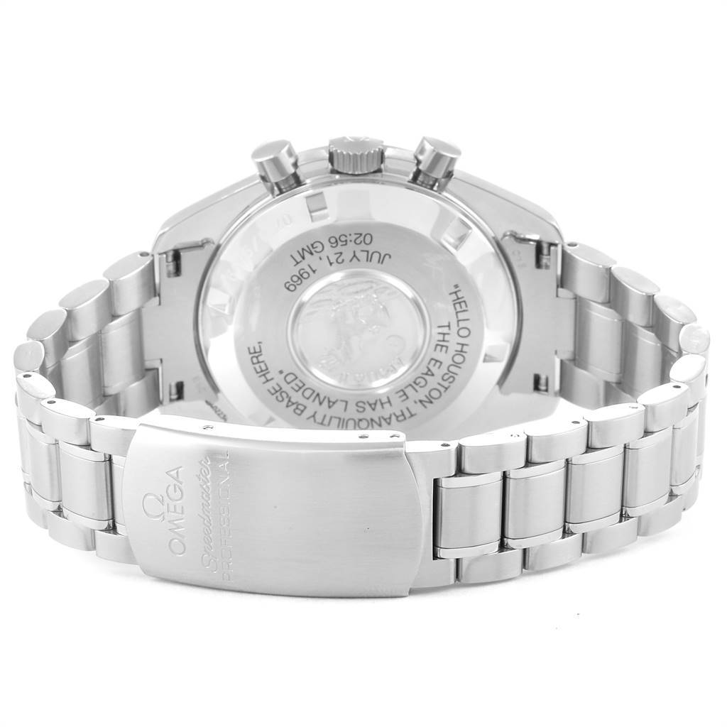 The image shows the back of an Omega Speedmaster 3560.50.00 Men
s Stainless Steel Black Dial 3560.50.00 Men
s Stainless Steel Black Dial watch, displaying its clasp, bracelet, and the engraved case back.