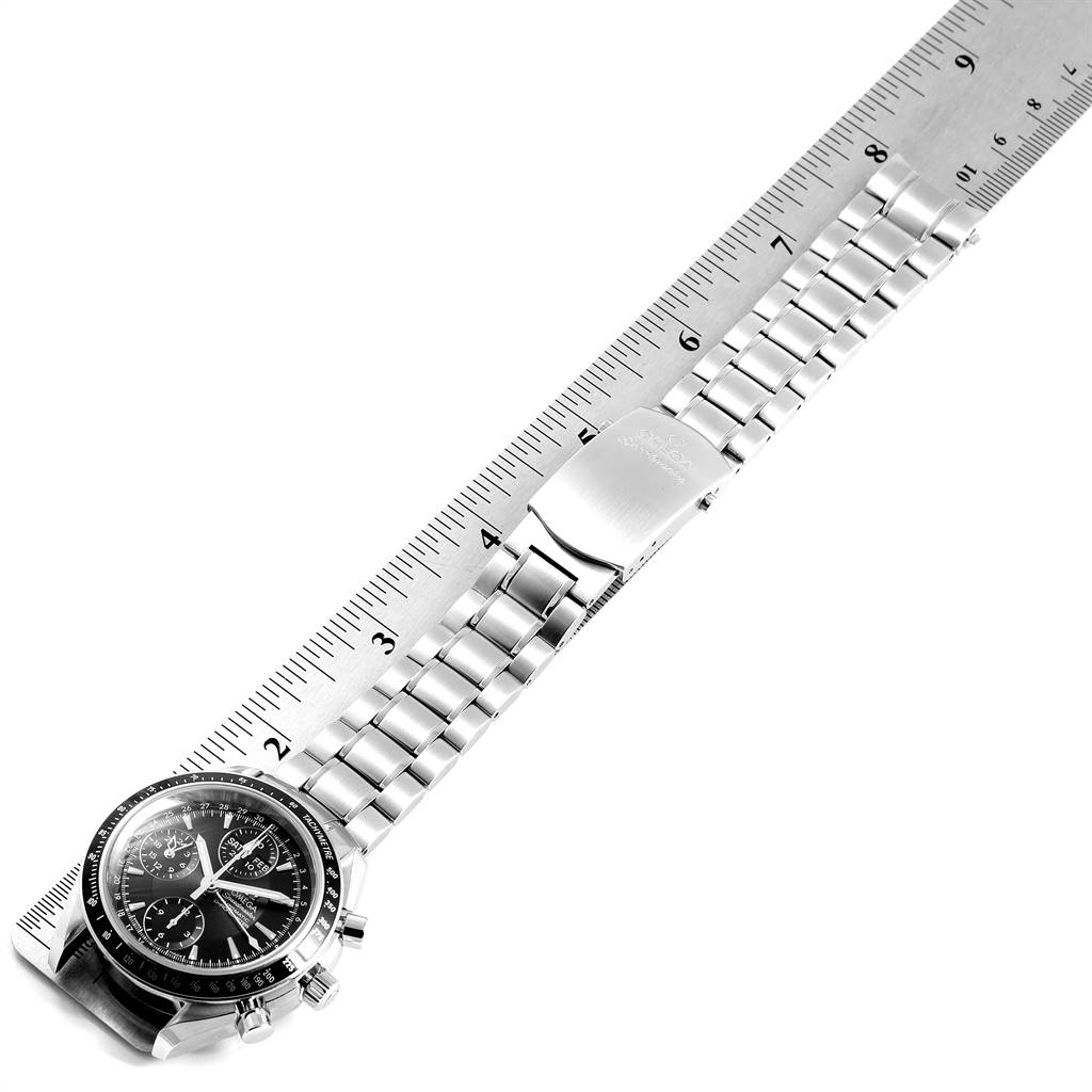 The image shows an Omega Speedmaster 3220.50.00 Men
s Stainless Steel Black Dial 3220.50.00 Men
s Stainless Steel Black Dial watch laid flat with a ruler measuring its bracelet.