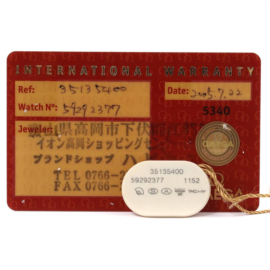 The image shows an Omega Speedmaster 3513.54.00 Men's Stainless Steel Black Dial 3513.54.00 Men's Stainless Steel Black Dial International Warranty card and a tag with model and serial numbers.