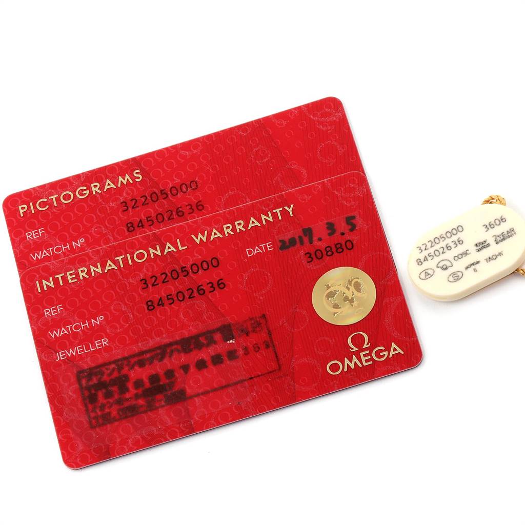 The image shows the international warranty and pictogram cards for the Omega Speedmaster 3220.50.00 Men
s Stainless Steel Black Dial 3220.50.00 Men
s Stainless Steel Black Dial watch along with its tag.