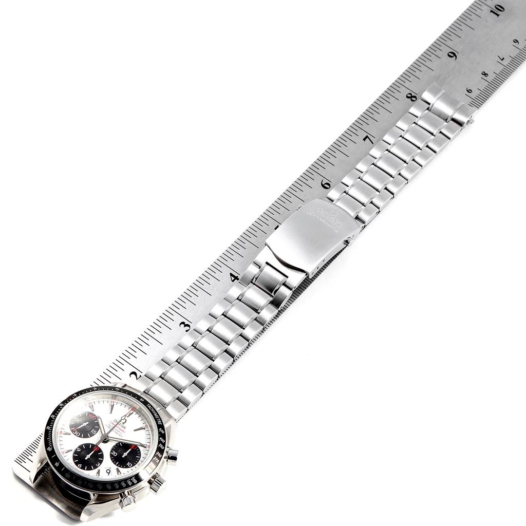 This image shows an Omega Speedmaster 323.30.40.40.04.001 Men's Stainless Steel White Dial 323.30.40.40.04.001 Men's Stainless Steel White Dial watch laid flat with a metal bracelet and clasp, against a ruler for scale.