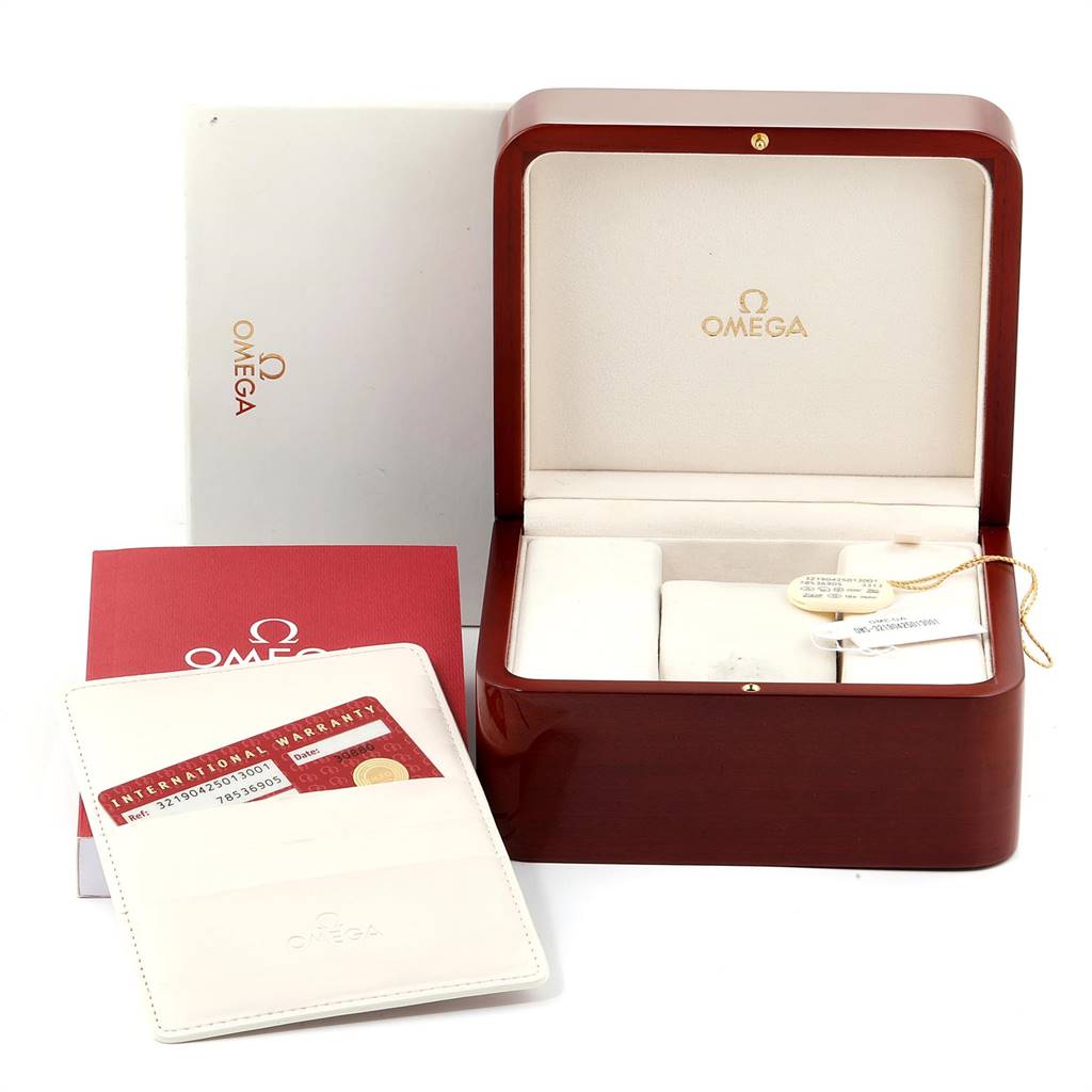 The image shows the Omega Speedmaster 321.90.42.50.13.001 Men's Steel and Gold (two tone) Brown Dial 321.90.42.50.13.001 Men's Steel and Gold (two tone) Brown Dial watch's open box, warranty card, and accompanying documents from a front angle.