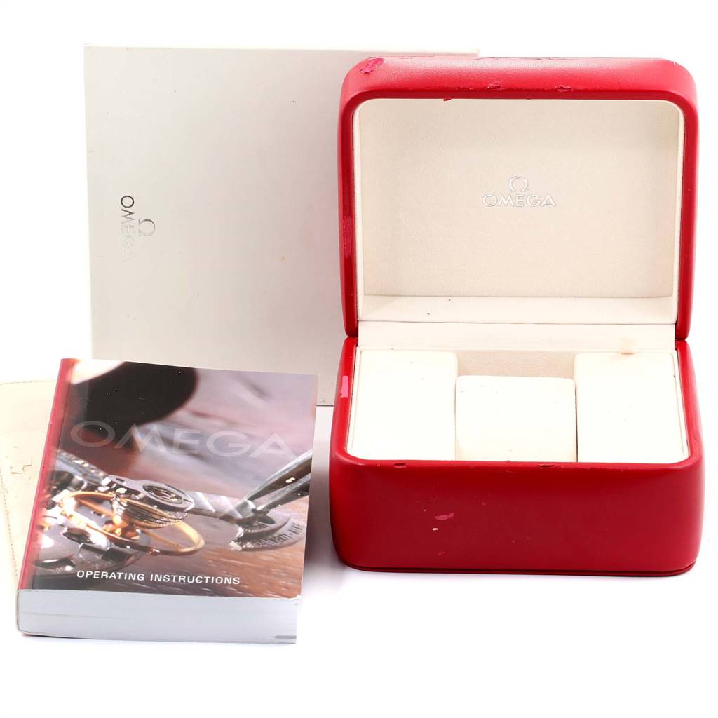 This image shows a red Omega Speedmaster 3506.31.00 Men's Stainless Steel Silver Dial 3506.31.00 Men's Stainless Steel Silver Dial watch box, an operating instructions manual, and outer packaging.