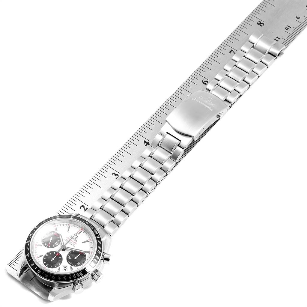 The Omega Speedmaster 323.30.40.40.04.001 Men
s Stainless Steel White Dial 323.30.40.40.04.001 Men
s Stainless Steel White Dial watch is shown at a slight angle, displaying its face, metal bracelet, and clasp alongside a ruler for scale.