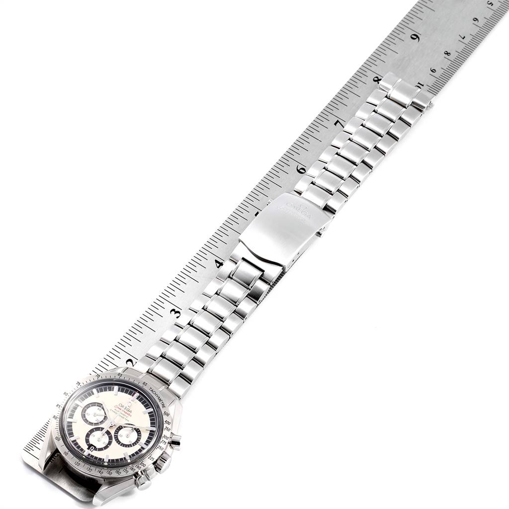 The Omega Speedmaster 3506.31.00 Men
s Stainless Steel Silver Dial 3506.31.00 Men
s Stainless Steel Silver Dial watch is shown from a top-down angle, highlighting its face and metal bracelet beside a ruler.