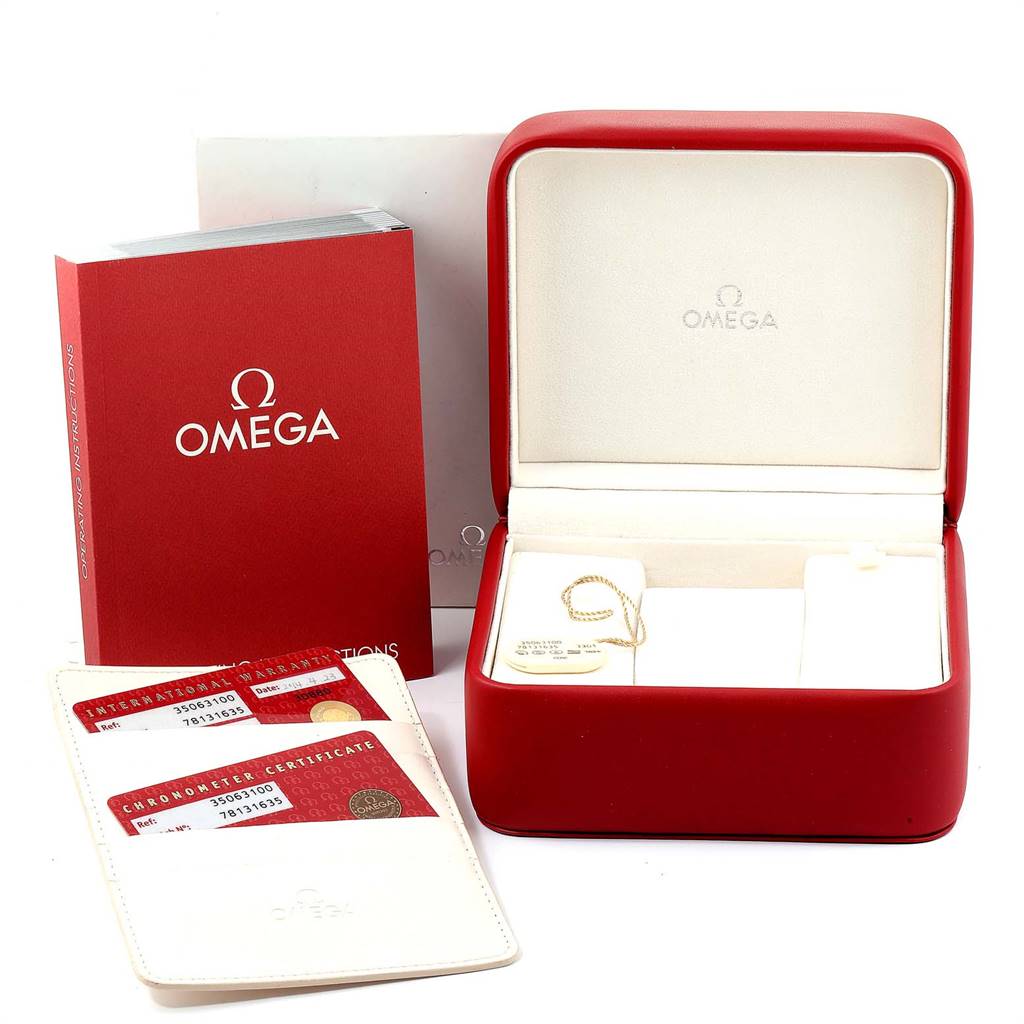 The image shows a red Omega Speedmaster 3506.31.00 Men
s Stainless Steel Silver Dial 3506.31.00 Men
s Stainless Steel Silver Dial watch box, warranty cards, a manual, and a certificate holder.