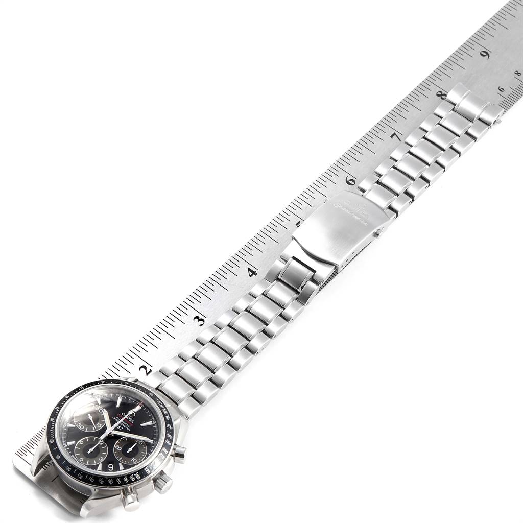 The Omega Speedmaster 323.30.40.40.01.001 Men
s Stainless Steel Black Dial 323.30.40.40.01.001 Men
s Stainless Steel Black Dial watch is shown diagonally with its face and stainless steel bracelet atop a ruler.