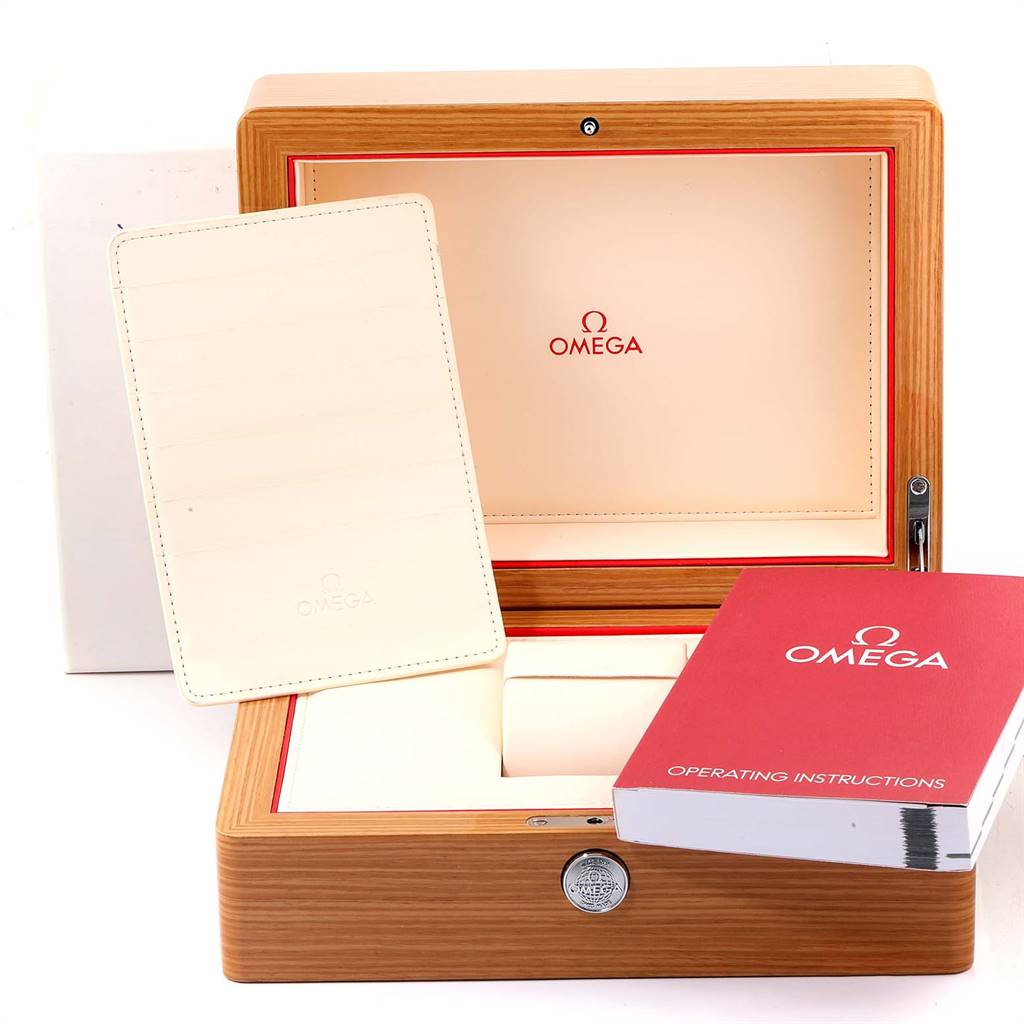 The image shows the packaging and accessories for an Omega Speedmaster 321.90.44.52.01.001 Men's Titanium Black Dial 321.90.44.52.01.001 Men's Titanium Black Dial, including the box, instructions, and cardholder.