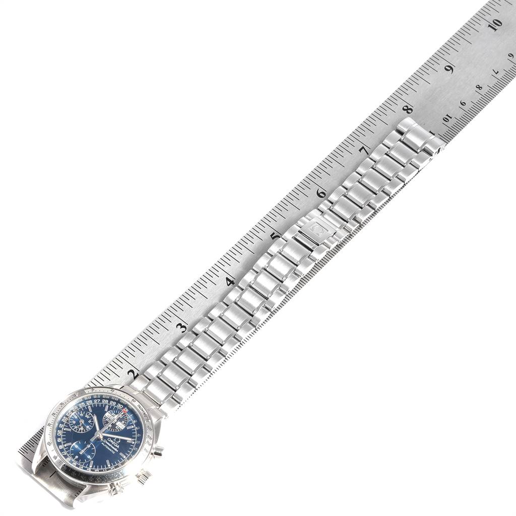 This Omega Speedmaster 3523.80.00 Men
s Stainless Steel Blue Dial 3523.80.00 Men
s Stainless Steel Blue Dial watch is shown diagonally with its face and full bracelet measured against a ruler.