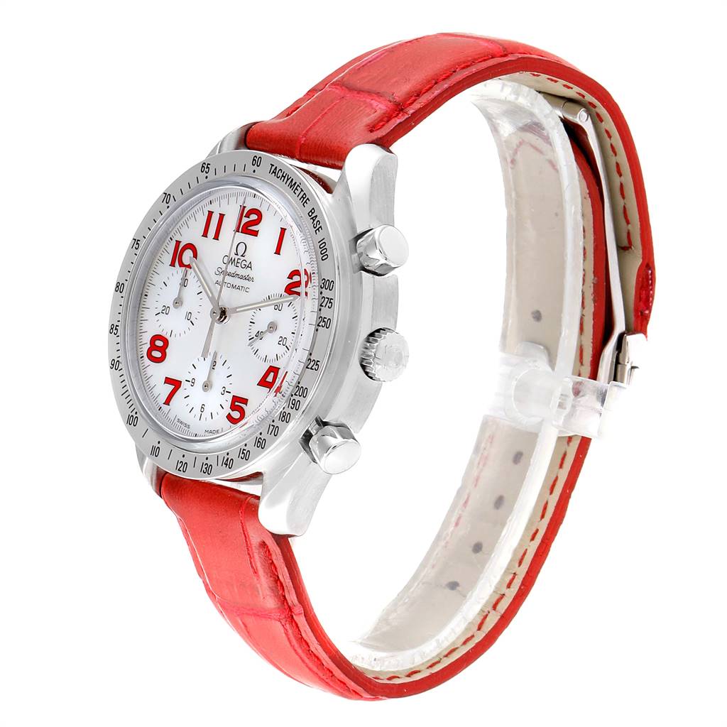 The Omega Speedmaster 3834.79.40 Women's Stainless Steel Mother of Pearl Dial 3834.79.40 Women's Stainless Steel Mother of Pearl Dial watch is shown at an angle highlighting its red leather strap, silver case, white dial, and chronograph pushers.