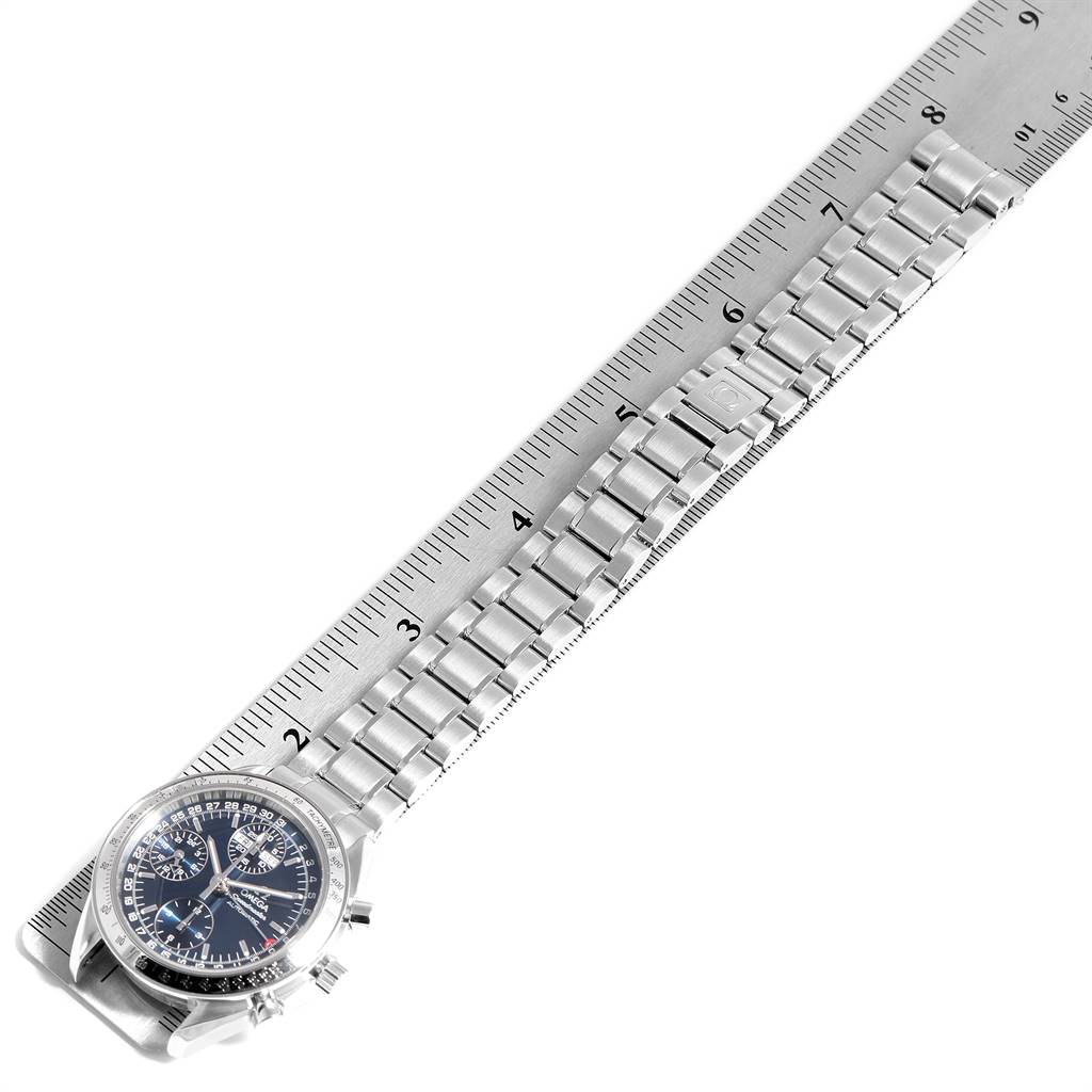 The image shows the Omega Speedmaster 3523.80.00 Men
s Stainless Steel Blue Dial 3523.80.00 Men
s Stainless Steel Blue Dial watch from an overhead angle, detailing the face and stainless steel band against a ruler for scale.