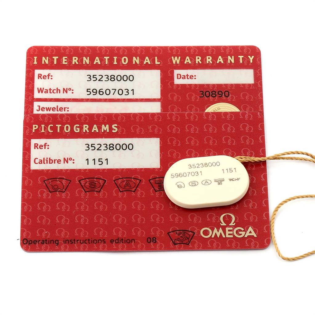 This image shows an Omega Speedmaster 3523.80.00 Men
s Stainless Steel Blue Dial 3523.80.00 Men
s Stainless Steel Blue Dial International Warranty card and a tag with reference and caliber numbers.