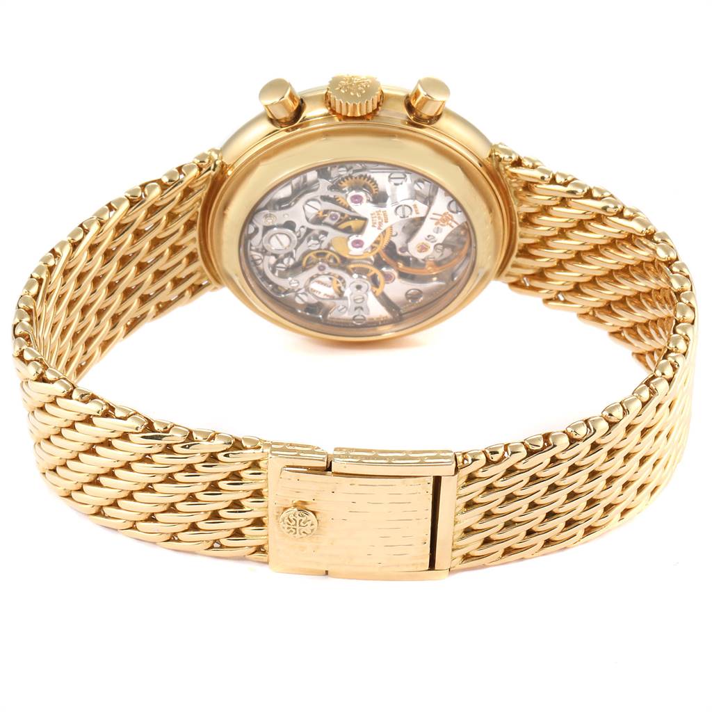 The image shows the back view of the Patek Philippe 3970 Men's Yellow Gold Silver Dial 3970 Men's Yellow Gold Silver Dial Perpetual Calendar Chronograph Yellow Gold Mens Watch 3970, displaying its transparent case back and gold bracelet.