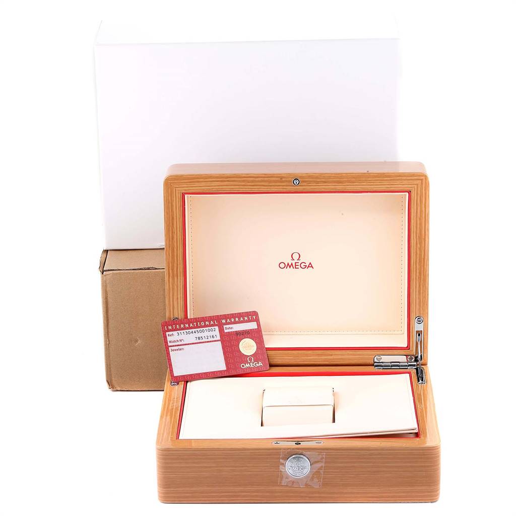 The image shows the packaging of an Omega Speedmaster 311.30.44.50.01.002 Men
s Stainless Steel Black Dial 311.30.44.50.01.002 Men
s Stainless Steel Black Dial watch, including its wooden box and warranty card.